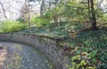 Curving Concave Stone Wall with Ivy Groundcover