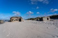 Old stone constructions on the sandy beach in Nationalpark Thy, Denmark.