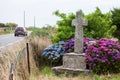 Old stone cross and car