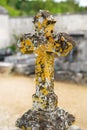 Old stone cross with lichen