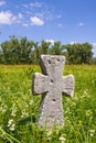 Old stone cross on meadow Royalty Free Stock Photo