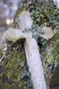 Old stone cross overgrown with ivy and moss Royalty Free Stock Photo