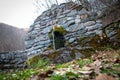 Old stone drinking fountain in the forest Royalty Free Stock Photo