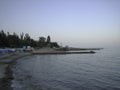 Old stone embankment over a rocky beach at sunset Royalty Free Stock Photo