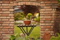 Old stone entrance wall in the garden with table and bowl of nuts Royalty Free Stock Photo