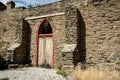 Old stone exterior wall and door of rustic historic building in street in Clyde in South Island