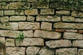 Old stone fence. Cracks between the stones. Moss on the ruined wall Royalty Free Stock Photo