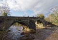 The old Stone Footbridge crowing the River Wharfe at Ilkley in West Yorkshire Royalty Free Stock Photo