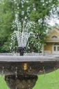 Old stone fountain closeup with dripping water