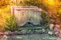 Old stone fountain with water flowing from a faucet Royalty Free Stock Photo