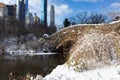 Gapstow Bridge over the Pond at Central Park during the Winter with Beautiful Snow in New York City and the Midtown Manhattan Skyl Royalty Free Stock Photo