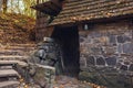 Old stone granite house with staircase on slope in autumn forest Royalty Free Stock Photo