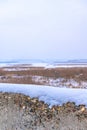 Old stone hedge covered with snow. Vertical photography Royalty Free Stock Photo