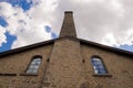 An old stone house with arched windows and a chimney. Victorian style. Vintage architecture detail Royalty Free Stock Photo