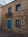 old stone house with blue doors and windows in mediterranean style at romantic mountain village Baunei Ogliastra Royalty Free Stock Photo