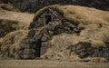 Old stone house destroyed ancient Viking overgrown with yellow dry grass Royalty Free Stock Photo