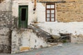 Old Stone House With Door and Window, Staircase, Rusty Gutter and Wheelbarrow Royalty Free Stock Photo