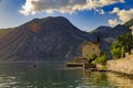 Old stone house in Kotor Bay with mountains and crystal clear water in the Balkans, Montenegro on the Adriatic Sea Royalty Free Stock Photo