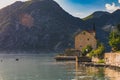 Old stone house in Kotor Bay with mountains and crystal clear water in the Balkans, Montenegro on the on Adriatic Sea Royalty Free Stock Photo