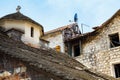 Old stone house in a poor neighborhood, standing next to a small ancient church. Royalty Free Stock Photo