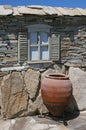 old stone house with window and a clay pitcher, Ikaria, Greek islands, Greece Royalty Free Stock Photo