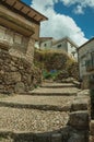 Old stone houses in cobblestone alley on slope with steps