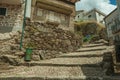 Old stone houses in cobblestone alley on slope with steps Royalty Free Stock Photo