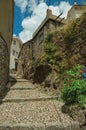 Old stone houses in cobblestone alley on slope with steps Royalty Free Stock Photo