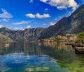 Old stone houses in Kotor Bay with mountains and crystal clear water in the Balkans, Montenegro on the Adriatic Sea Royalty Free Stock Photo