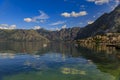 Old stone houses in Kotor Bay with mountains and crystal clear water in the Balkans, Montenegro on the Adriatic Sea Royalty Free Stock Photo