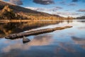 The old stone jetty on the shore of a very still Loch Ard. Stirlingshire, Scotland Royalty Free Stock Photo