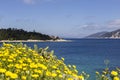 Old, stone lighthouse (Kefalonia Island, Greece) against the backdrop of the sea and mountains