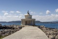 Old, stone lighthouse (Kefalonia Island, Greece) against the backdrop of the sea and mountains