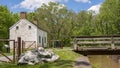 An old stone lock house, reminiscent of older times, stands beside the C&O Canal in rural Maryland.