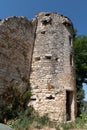 Old stone medieval tower in OppÃÂ¨de le Vieux village cliff in Luberon France