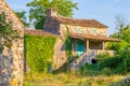 Old stone mediterranean house ruins with ivy and grass