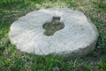 Old stone millstone in the grass Royalty Free Stock Photo