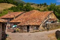 Old stone mountain mansions, red roofs. Carmona, Cantabria, Spain