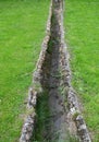 Old stone paved road water ditch