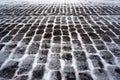 Old stone pavement covered with snow in winter Royalty Free Stock Photo