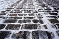 Old stone pavement covered with snow in winter Royalty Free Stock Photo