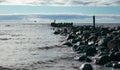 An old stone pier in to the sea on a sunny evening. Dramatic look Royalty Free Stock Photo