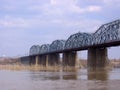 Old stone railway bridge Komsomolsky across the Ob river in Novosibirsk in autumn Royalty Free Stock Photo