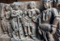 Old stone sculpture with drummer and people listening music. Relief of the 12th century Hoysaleshwara temple in India Royalty Free Stock Photo