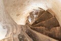 Old stone spiral staircase in a castle or old Church. Bottom view of the stairs and narrow passage. Historical value and culture Royalty Free Stock Photo