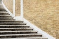 Old stone spiraling stairs near brick wall