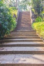 Old stone stair case in the ancient temple with green trees surrounding. Peaceful stone path going uphill in the forest leading up Royalty Free Stock Photo