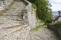 Old stone staircase with a sharp turn leading from the slope to the village Royalty Free Stock Photo