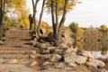 Old stone stairs in autumn. Staircase in steps among yellow foliage and big rocks. Royalty Free Stock Photo