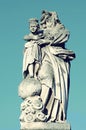 Old stone statue of Jesus and Our Lady of partially destroyed he